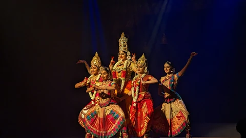 Traditional Bharatanatyam dancer in vibrant costume performing authentic classical Indian dance with graceful expressions